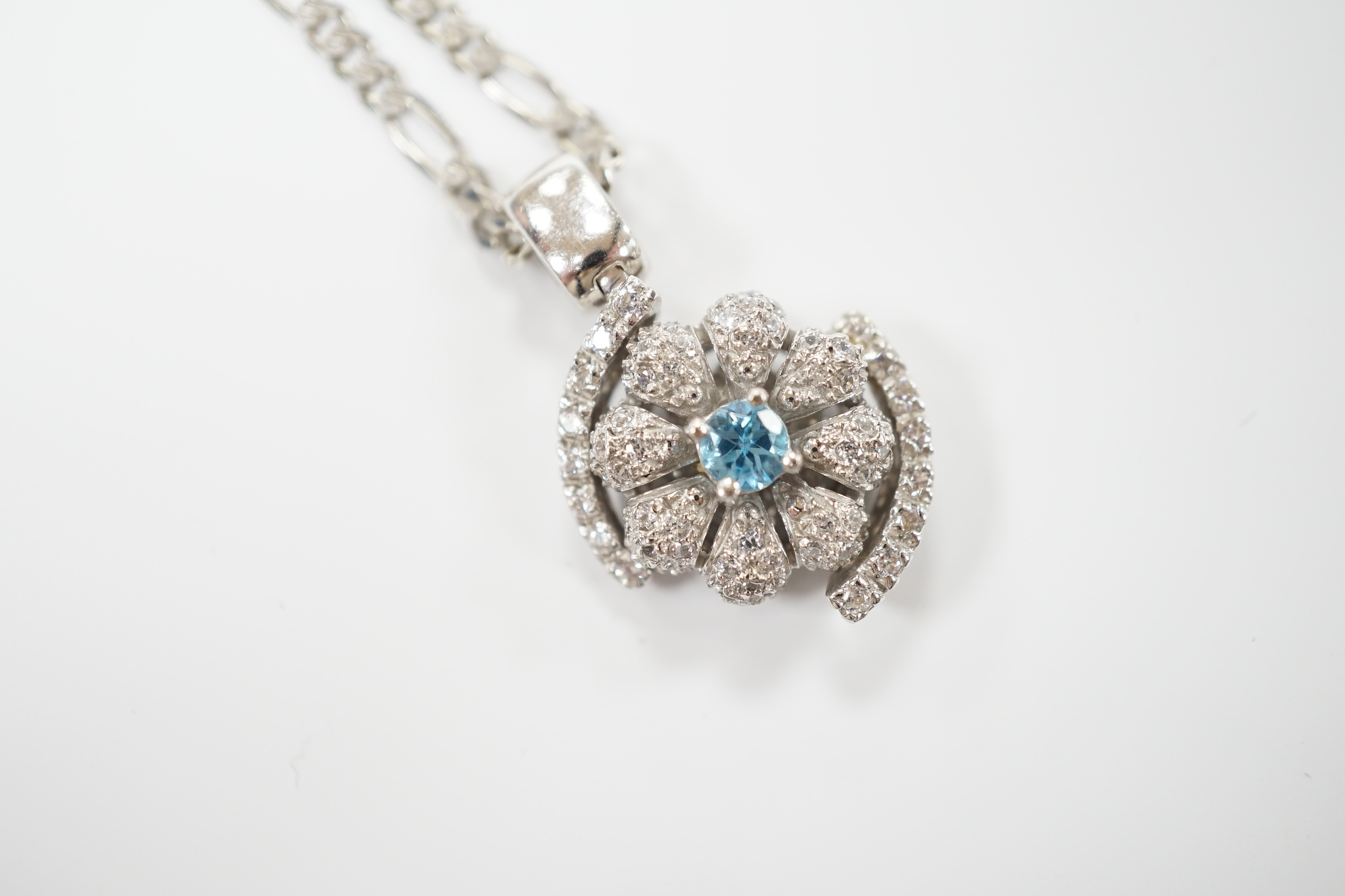 A modern 14ct gold, topaz? and simulated diamond chip cluster set pendant, 20mm, on a 9ct chain, 44cm, gross weight 11.2 grams
